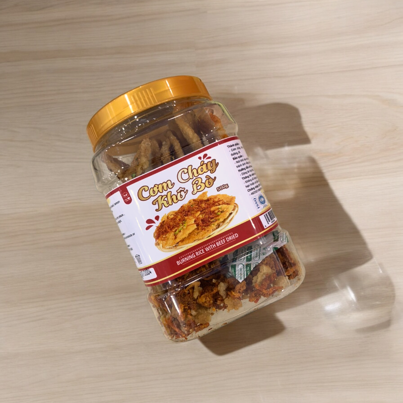 24703_z5642162346461-16090b4f7ba5ad6172c72dc3ff483156-photoroom_20240718110423-1.png Cơm Cháy Khô Bò 500g hộp - 8936208933326
